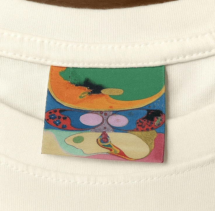 Embroidered pocket detail on white cotton